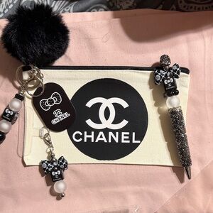 Black and White 4 piece set includes pouch, pen, keychain & phone charm.